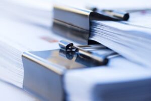 Large stack of legal documents awaiting review for pre-litigation analysis by San Francisco-PI