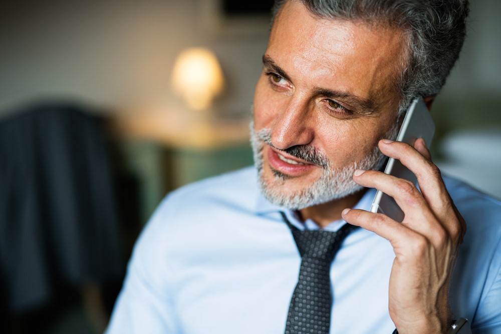 Attorney on the phone with a San Francisco private investigator discussing litigation support for a law firm case